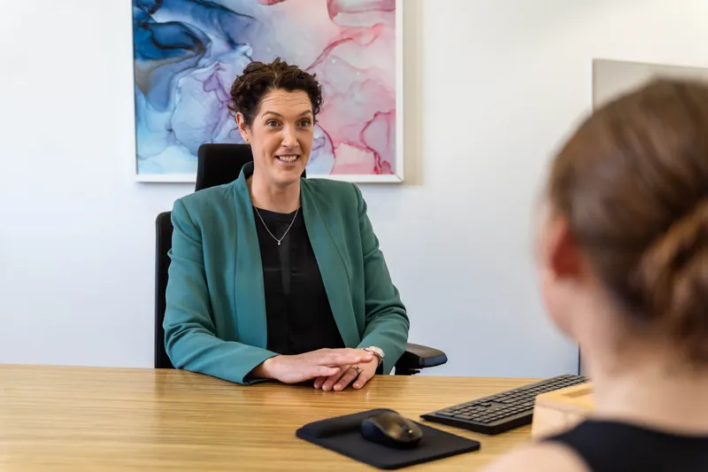 Dr Eliza Malkoun smiling during a consultation